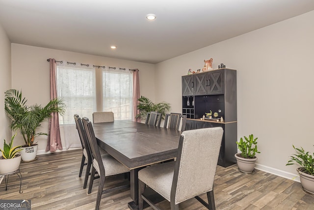 dining space with hardwood / wood-style flooring