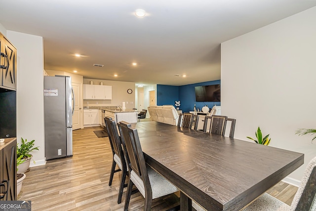 dining space with light hardwood / wood-style floors