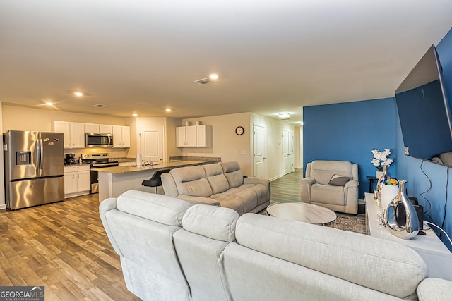 living room with sink and light hardwood / wood-style floors