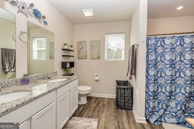 bathroom featuring vanity, hardwood / wood-style flooring, toilet, and a shower with shower curtain