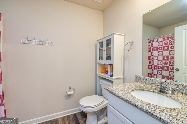 bathroom featuring vanity, hardwood / wood-style floors, and toilet