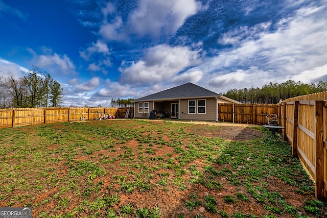 back of house with a lawn