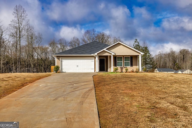 view of front of home with a garage and a front lawn