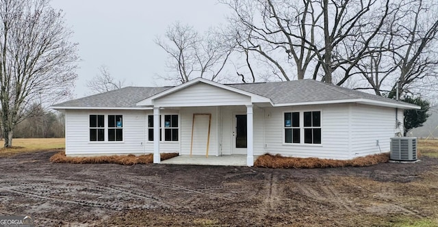 ranch-style house featuring cooling unit and a patio