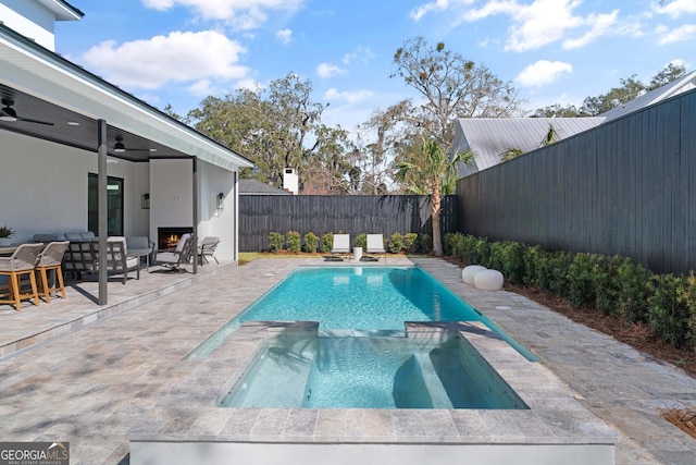 view of pool featuring an in ground hot tub, ceiling fan, and a patio