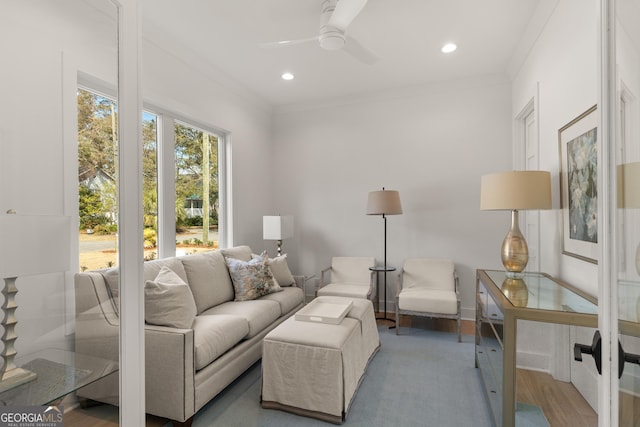 living room featuring crown molding, ceiling fan, and hardwood / wood-style floors