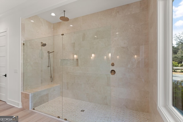 bathroom featuring a tile shower and hardwood / wood-style flooring