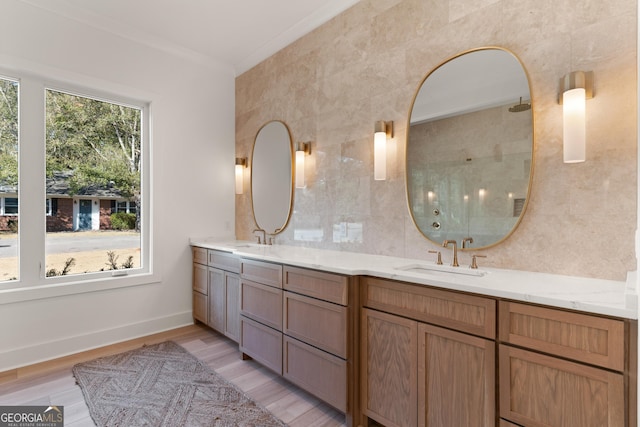 bathroom with hardwood / wood-style flooring, ornamental molding, tile walls, and vanity