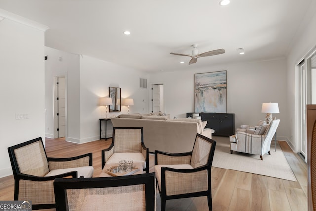 living room with ceiling fan and light hardwood / wood-style floors