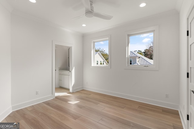 unfurnished bedroom with crown molding, ensuite bath, and light wood-type flooring