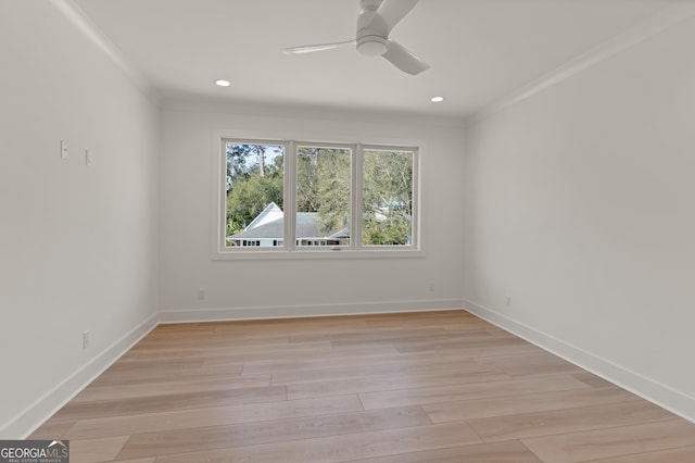 empty room with crown molding, ceiling fan, and light wood-type flooring