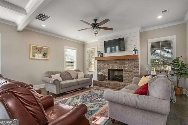 living room with ornamental molding, dark wood-type flooring, a fireplace, and ceiling fan