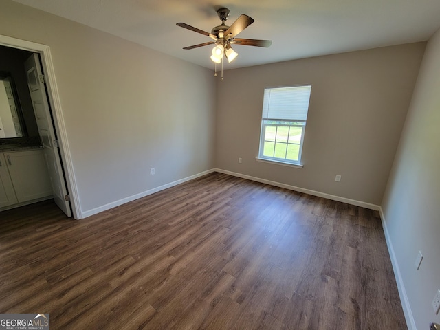 empty room with dark wood-type flooring and ceiling fan