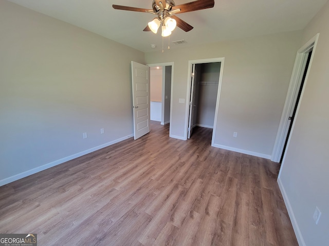 unfurnished bedroom with a closet, ceiling fan, and light wood-type flooring