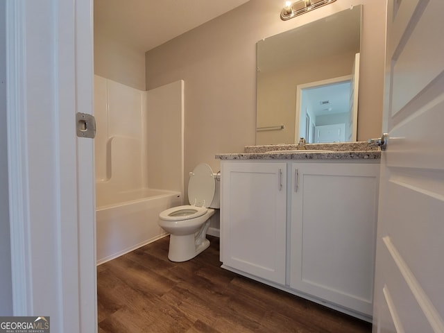 full bathroom with wood-type flooring, shower / bathing tub combination, vanity, and toilet