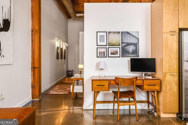 office area featuring beam ceiling and a high ceiling