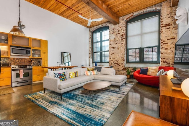 living room with beamed ceiling, a towering ceiling, wooden ceiling, and ceiling fan