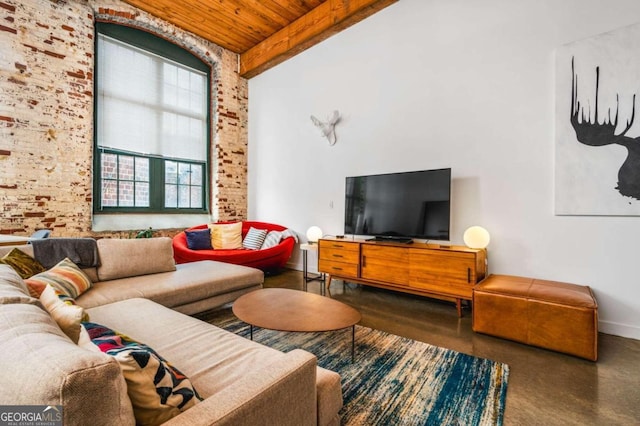 living room featuring wooden ceiling, beamed ceiling, and brick wall