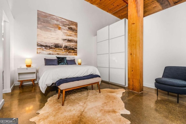 bedroom featuring a towering ceiling and wooden ceiling