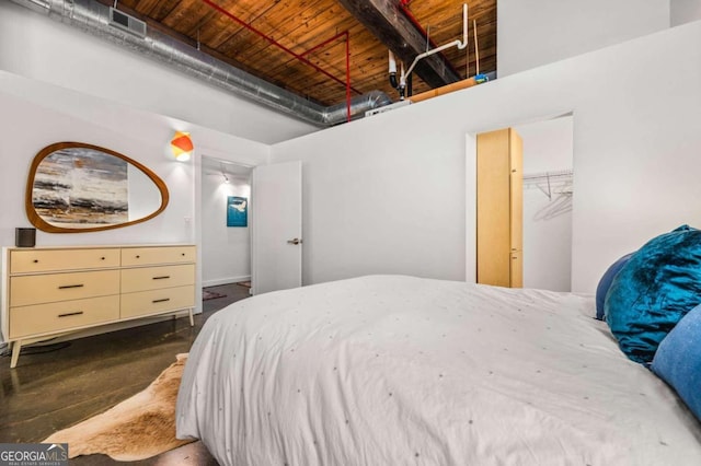 bedroom with a spacious closet and wooden ceiling