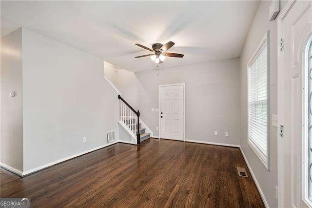 interior space with dark wood-type flooring and ceiling fan