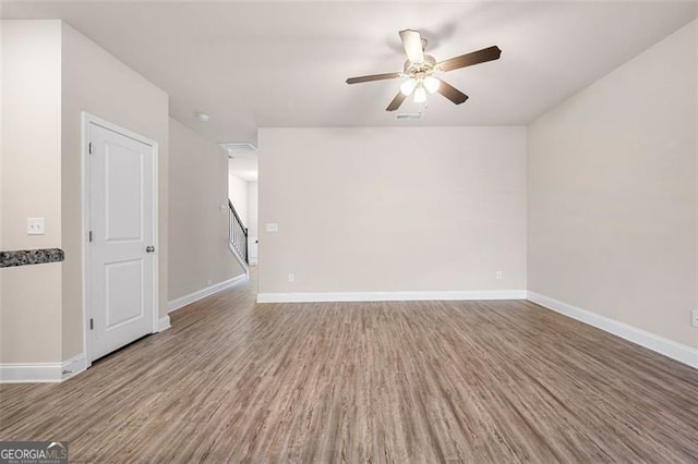 spare room featuring ceiling fan and hardwood / wood-style floors