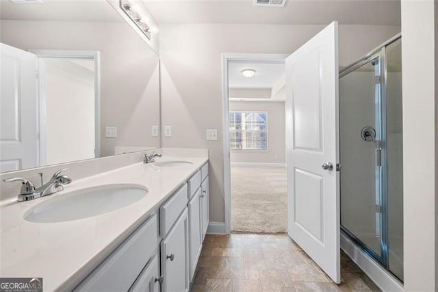 bathroom with walk in shower and vanity