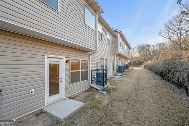 view of side of home featuring cooling unit