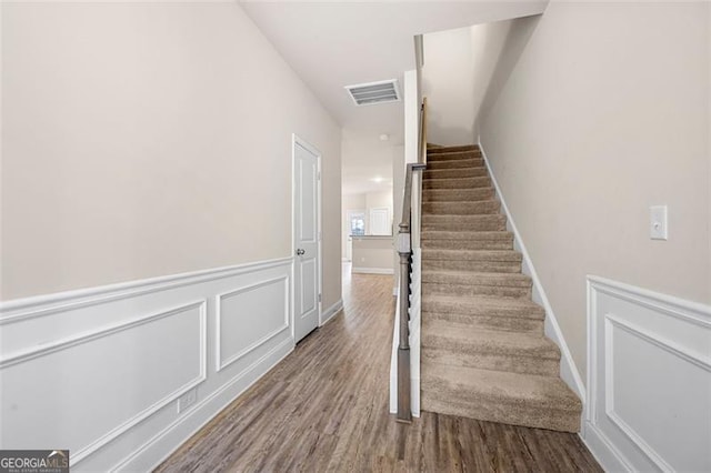 stairway featuring wood-type flooring