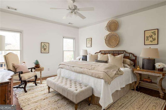 bedroom with multiple windows, ornamental molding, light hardwood / wood-style floors, and ceiling fan