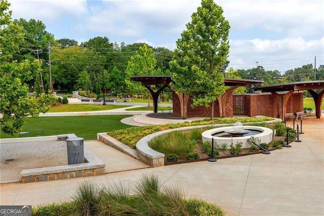 view of home's community featuring a patio area and a lawn