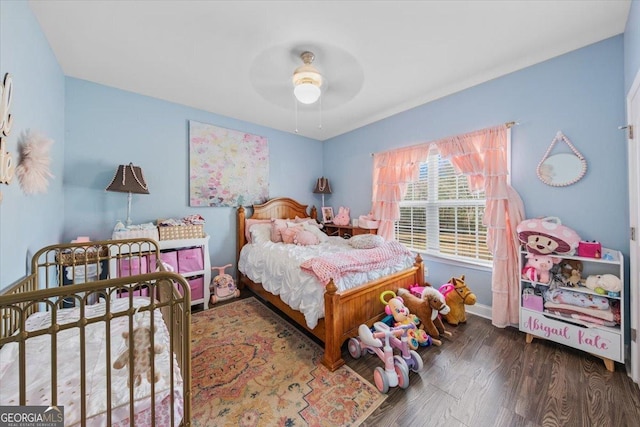 bedroom with ceiling fan and dark hardwood / wood-style flooring