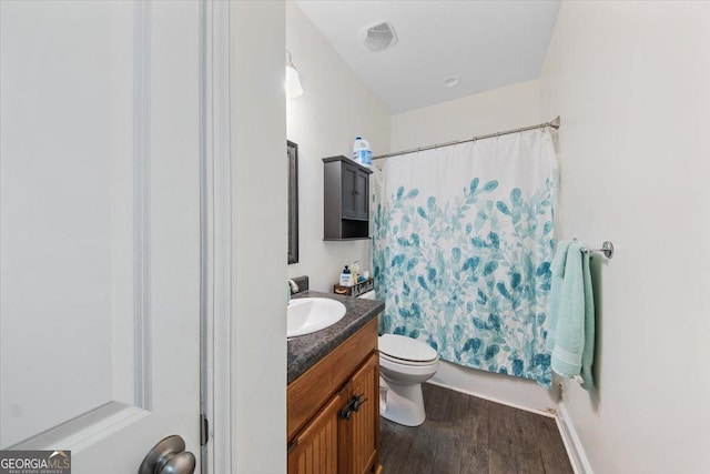 bathroom with hardwood / wood-style flooring, vanity, and toilet