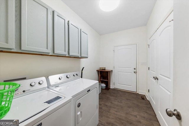 washroom featuring cabinets, dark wood-type flooring, and independent washer and dryer