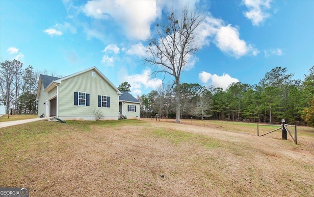 view of side of home with a garage and a yard