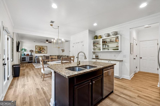 kitchen featuring dishwasher, sink, light stone countertops, dark brown cabinets, and light hardwood / wood-style flooring