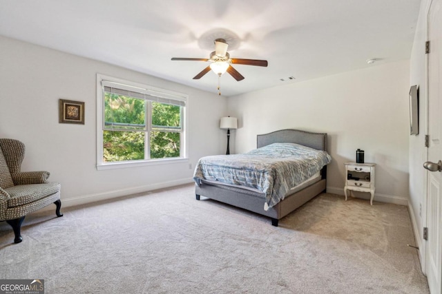 bedroom with light carpet and ceiling fan