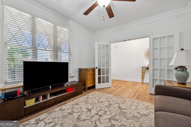 living room with hardwood / wood-style flooring, ceiling fan, ornamental molding, and french doors