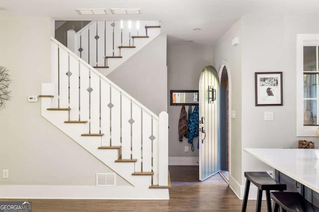 foyer entrance featuring dark wood-type flooring