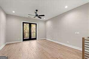 unfurnished room with french doors, ceiling fan, and light wood-type flooring