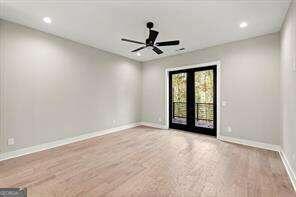 spare room with french doors and ceiling fan