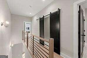 hallway featuring a barn door