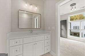 bathroom featuring crown molding and vanity