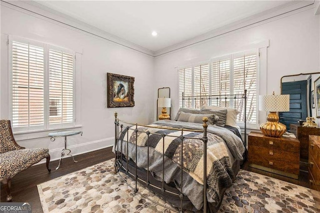 bedroom with crown molding and wood-type flooring