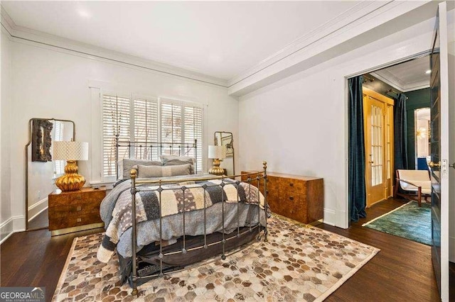 bedroom featuring crown molding and dark hardwood / wood-style floors