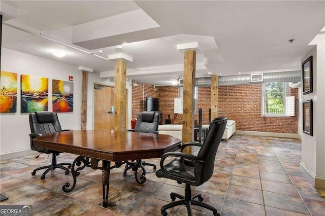 office space with brick wall and ornate columns