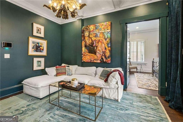 living room featuring crown molding, hardwood / wood-style floors, and a notable chandelier