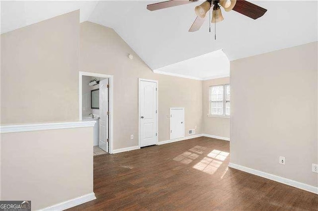 interior space with dark hardwood / wood-style flooring, vaulted ceiling, and ceiling fan