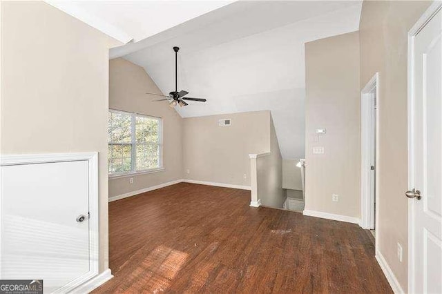 unfurnished living room featuring lofted ceiling, dark hardwood / wood-style floors, and ceiling fan