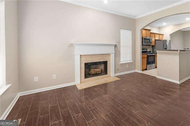 unfurnished living room featuring crown molding